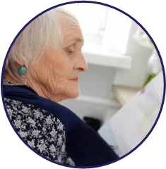 Older woman reading a book.