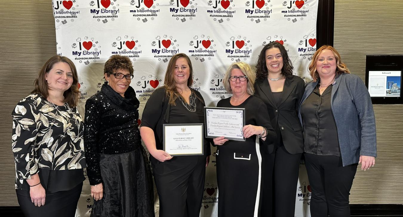 Library staff and board member holding their two awards at the OLA Super Conference gala on January 25, 2024.