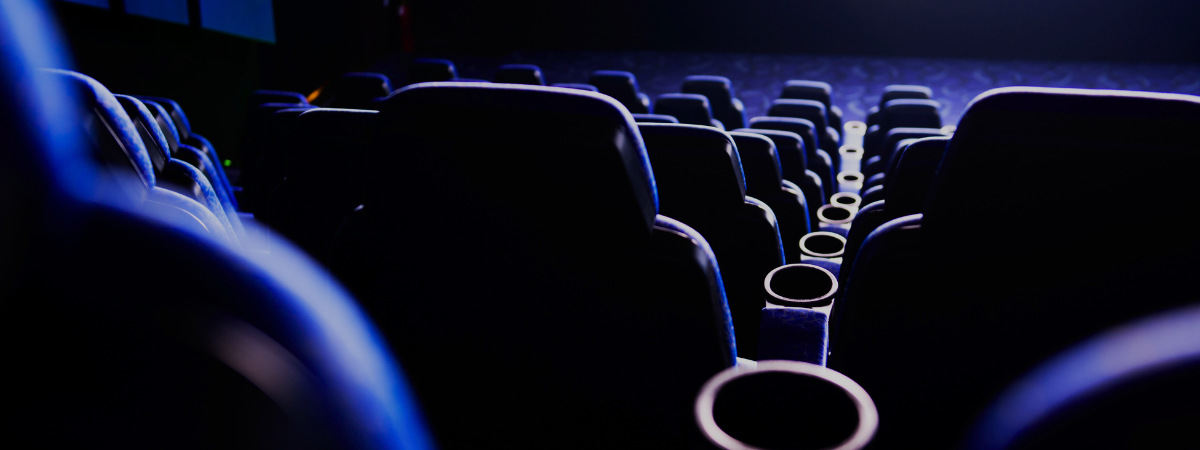 Seats inside a movie theatre in a dark blue glow.