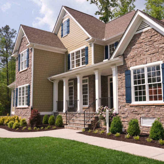 Two storey brown brick house.