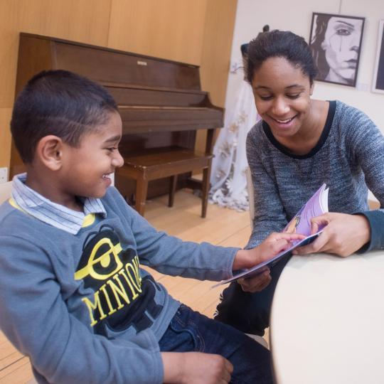 Woman reading with young boy image