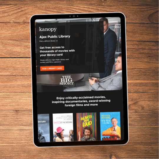 A black tablet on a brown wood table