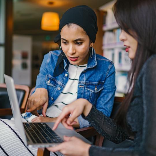 Two women at a computer.