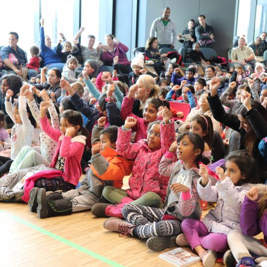 Group of children and families at an event.