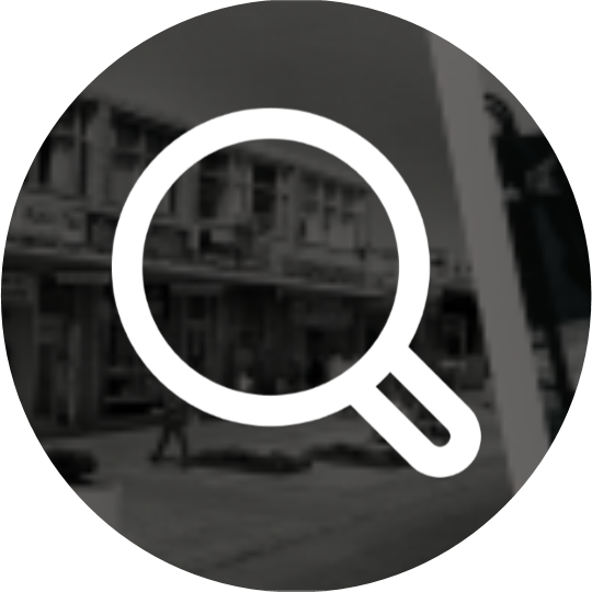 Black and white photograph in the background of a white search icon.