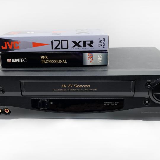 VHS player with two VHS tapes on top.