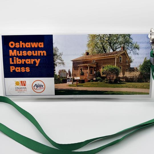 Oshawa Museum Library Pass on a green lanyard.