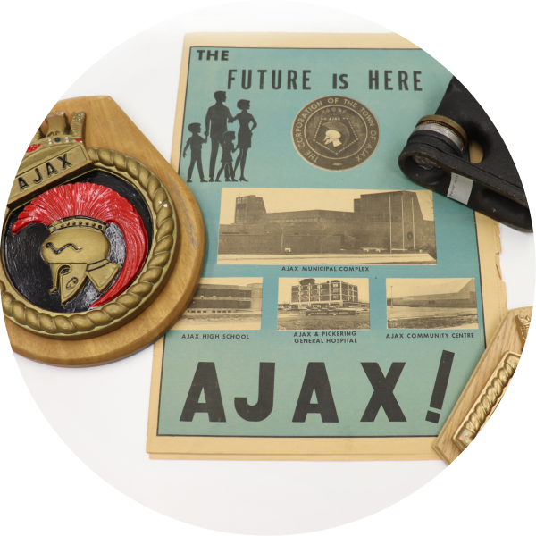 The Town of Ajax seal, an old promotional publication, and press. 